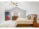 Comfortable bedroom features a dresser, a large window and a vaulted ceiling at 6336 Lake Valley Pt, Lithonia, GA 30058