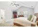 A well-lit bedroom featuring vaulted ceilings and a cozy bed with decorative pillows at 6336 Lake Valley Pt, Lithonia, GA 30058