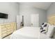 Bright bedroom featuring light walls and a matching dresser, with an adjacent room at 6336 Lake Valley Pt, Lithonia, GA 30058