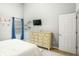Bedroom with blue curtains, complemented by light walls and a matching dresser at 6336 Lake Valley Pt, Lithonia, GA 30058