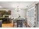 This dining area features a chandelier, wainscoting, and a large window for natural light at 6336 Lake Valley Pt, Lithonia, GA 30058