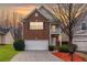 Charming two-story brick home with attached two-car garage, manicured landscaping, and inviting front porch area at 6336 Lake Valley Pt, Lithonia, GA 30058