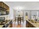 Kitchen with stainless steel appliances, granite countertops, and an adjacent dining area at 6336 Lake Valley Pt, Lithonia, GA 30058