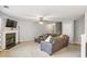 Spacious living room with a fireplace, plush seating, and a modern ceiling fan at 6336 Lake Valley Pt, Lithonia, GA 30058