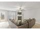 Spacious living room featuring a fireplace, plush sofa, ceiling fan, and back door at 6336 Lake Valley Pt, Lithonia, GA 30058