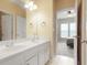 Bathroom includes a double sink vanity and a view of a bedroom through an open doorway at 3162 Abbey Sw Dr, Atlanta, GA 30331