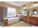 The primary bathroom includes a soaking tub with designer window and glass shower at 3162 Abbey Sw Dr, Atlanta, GA 30331