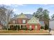 This charming two-story home boasts a well-manicured lawn, mature landscaping, and classic architectural details at 3162 Abbey Sw Dr, Atlanta, GA 30331