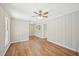 Bedroom with neutral wood-paneled walls, vinyl plank flooring, and natural light at 3339 Brenda Ln, Lithia Springs, GA 30122