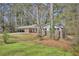 Brick home with covered carport surrounded by mature trees and green lawn at 3339 Brenda Ln, Lithia Springs, GA 30122