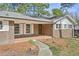 Brick home with covered front porch and lush landscape walkway leading to front door at 3339 Brenda Ln, Lithia Springs, GA 30122