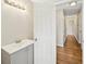 Hallway with hardwood floors, door to bathroom, sink and vanity at 3339 Brenda Ln, Lithia Springs, GA 30122
