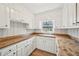 Bright kitchen featuring white cabinets, butcher block countertops, and updated sink at 3339 Brenda Ln, Lithia Springs, GA 30122