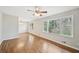 Open living room featuring hardwood floors, large windows, and a ceiling fan at 3339 Brenda Ln, Lithia Springs, GA 30122
