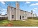 View of the backyard, home elevation, fence line, patio and lawn at 4022 Rosebud Park Dr, Snellville, GA 30039