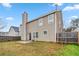 View of the backyard, home elevation, fence line, patio and lawn at 4022 Rosebud Park Dr, Snellville, GA 30039