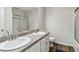 Well-lit bathroom with double sinks, granite countertops, white cabinets, and a shower-tub combo at 4022 Rosebud Park Dr, Snellville, GA 30039