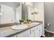 Bathroom featuring a double sink vanity with granite countertops, a large mirror, and white cabinets at 4022 Rosebud Park Dr, Snellville, GA 30039