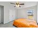 Bright bedroom with neutral walls, ceiling fan, closet and view of the backyard from the window at 4022 Rosebud Park Dr, Snellville, GA 30039