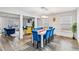 Bright dining area adjacent to living room, featuring hardwood floors and a large white dining table at 4022 Rosebud Park Dr, Snellville, GA 30039