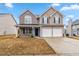 Charming two-story home featuring a brick and siding facade and an attached two-car garage at 4022 Rosebud Park Dr, Snellville, GA 30039