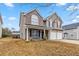 Lovely two-story home featuring a brick and siding facade, a covered porch, and a two-car garage at 4022 Rosebud Park Dr, Snellville, GA 30039