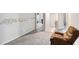 Upstairs hallway with carpet, alphabet wall art, and a comfy recliner at 4022 Rosebud Park Dr, Snellville, GA 30039