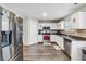 Bright kitchen featuring stainless steel appliances, white cabinets, and sleek countertops at 4022 Rosebud Park Dr, Snellville, GA 30039