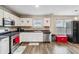 Charming kitchen with white cabinets, stainless steel appliances and sleek black countertops at 4022 Rosebud Park Dr, Snellville, GA 30039