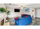 Bright living room with a fireplace, ceiling fan, and comfortable blue sofas, perfect for relaxation at 4022 Rosebud Park Dr, Snellville, GA 30039