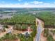 High-angle shot of the property showing its location near scenic wooded areas, roads and adjacent homes at 2705 Luke Edwards Rd, Dacula, GA 30019