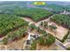Aerial view of home with wooded lot, long driveway, and proximity to Harrins Park Complex at 2705 Luke Edwards Rd, Dacula, GA 30019