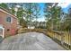 Spacious backyard deck surrounded by mature trees, offering peaceful outdoor living at 2705 Luke Edwards Rd, Dacula, GA 30019