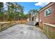 Staircase leading to the back patio, with brick exterior, dark roof, and serene wooded views at 2705 Luke Edwards Rd, Dacula, GA 30019