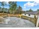 Expansive backyard deck leading to the lawn and separate garage with lush, wooded scenery at 2705 Luke Edwards Rd, Dacula, GA 30019