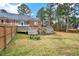 Large backyard with spacious deck, bench seating, stone table and natural landscaping at 2705 Luke Edwards Rd, Dacula, GA 30019