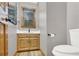 Bathroom featuring a toilet, vanity, window, and modern fixtures at 2705 Luke Edwards Rd, Dacula, GA 30019