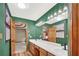 Contemporary bathroom with a long vanity, double sinks, and ample lighting at 2705 Luke Edwards Rd, Dacula, GA 30019