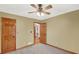 Bedroom with a ceiling fan and carpet, leading to a hallway with hardwood floors at 2705 Luke Edwards Rd, Dacula, GA 30019