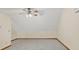View of a carpeted room featuring a ceiling fan, neutral walls, and wood trim at 2705 Luke Edwards Rd, Dacula, GA 30019