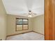 Cozy bedroom featuring a ceiling fan, neutral walls and plush carpet flooring at 2705 Luke Edwards Rd, Dacula, GA 30019
