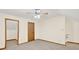 View of a carpeted room featuring a ceiling fan, neutral walls, and wood trim at 2705 Luke Edwards Rd, Dacula, GA 30019