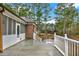 View of back deck featuring white railings, and a screened-in porch perfect for outdoor relaxing at 2705 Luke Edwards Rd, Dacula, GA 30019