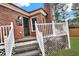Back porch featuring a brick exterior, white railings, outdoor lighting, and steps to the yard at 2705 Luke Edwards Rd, Dacula, GA 30019