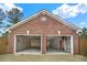 Exterior view of a brick two-car garage with open doors at 2705 Luke Edwards Rd, Dacula, GA 30019