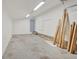 Unfinished garage space with concrete floor, white paneling, and utilitarian lighting at 2705 Luke Edwards Rd, Dacula, GA 30019