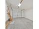 Unfinished garage with concrete floors, overhead lighting, and door at 2705 Luke Edwards Rd, Dacula, GA 30019