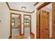 Hallway with doors to other rooms, and hardwood trim throughout at 2705 Luke Edwards Rd, Dacula, GA 30019