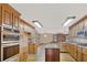 Spacious kitchen featuring stainless appliances, wooden cabinets, and hardwood floors at 2705 Luke Edwards Rd, Dacula, GA 30019