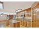 Well-equipped kitchen with stainless steel appliances, center island, and wooden cabinetry at 2705 Luke Edwards Rd, Dacula, GA 30019